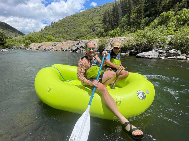 Two people rafting along the Provo River, near Bridal Veil Falls